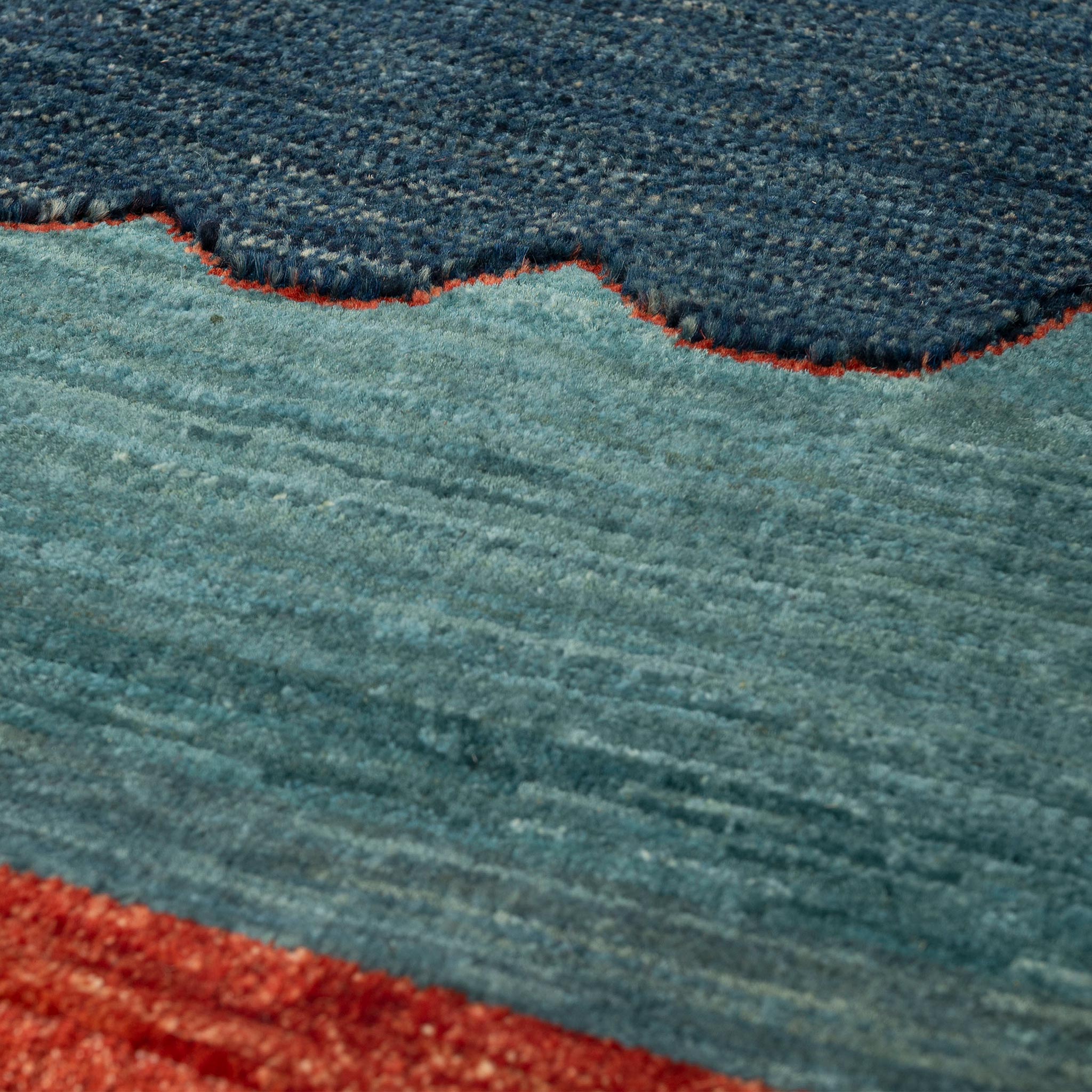 Closeup of ISHKAR's Pomegranate Blossom Wool Rug, a contemporary take on a timeless motif.