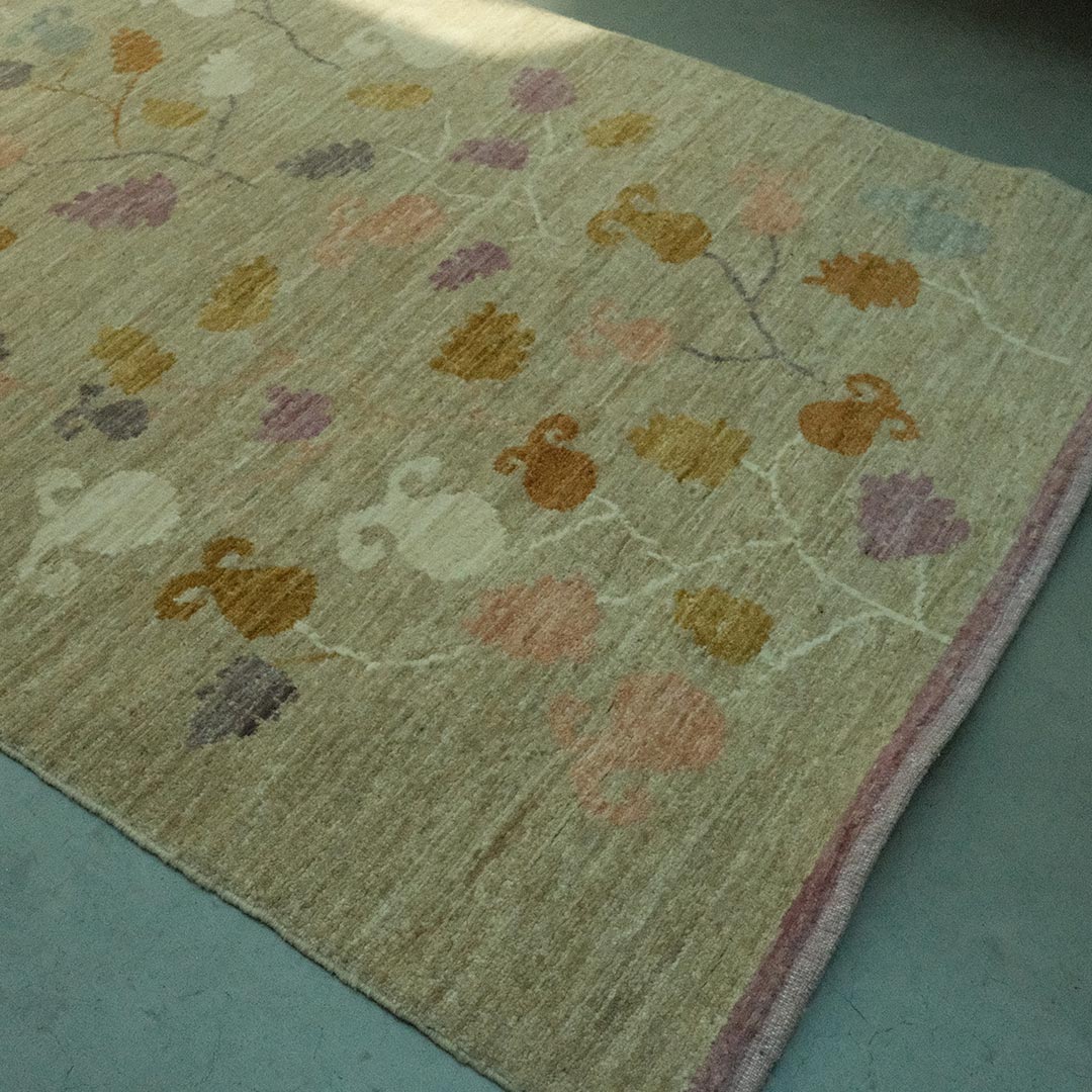 Patterned rug with colourful designs on a concrete floor
