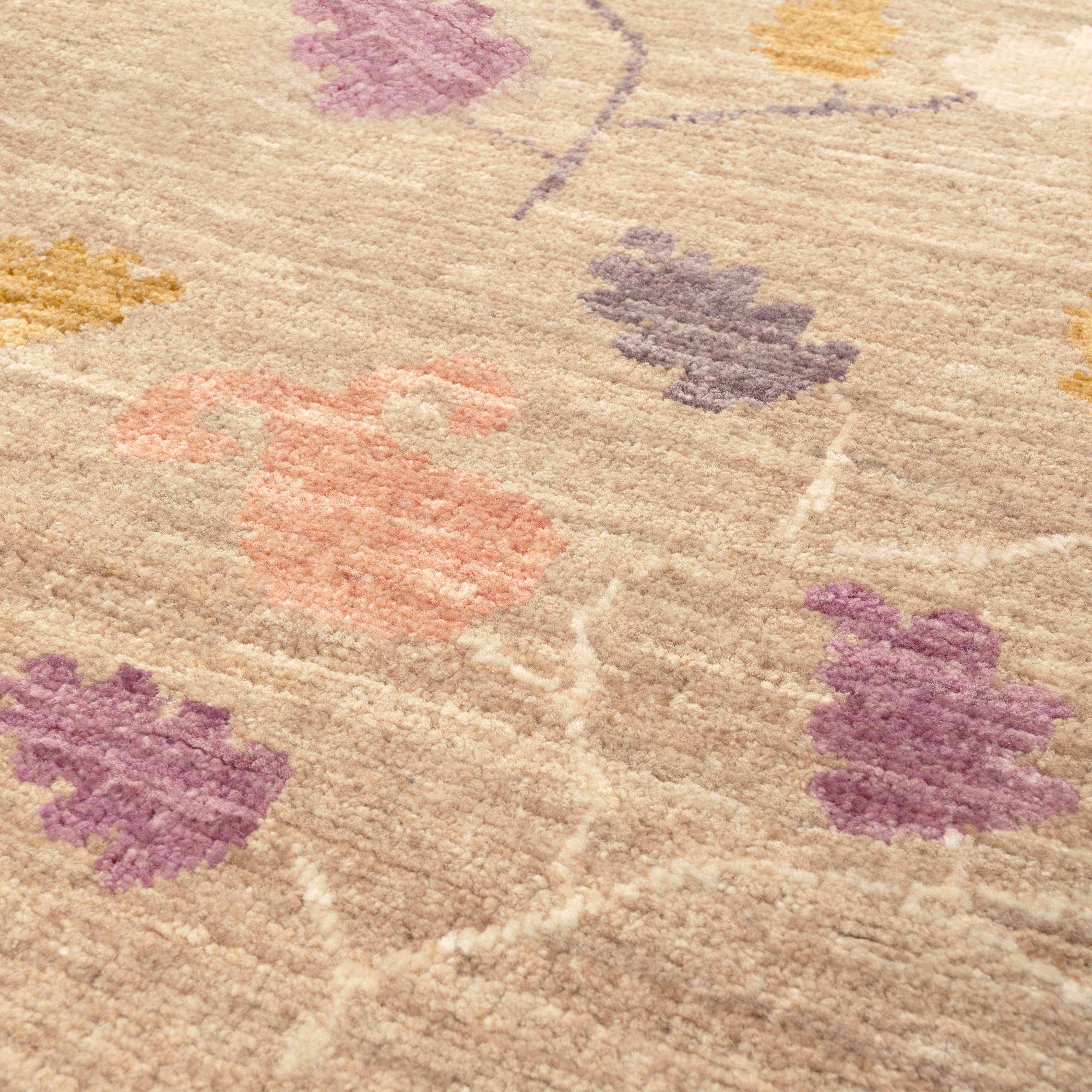 Close-up of a textured rug with floral patterns in pastel colours