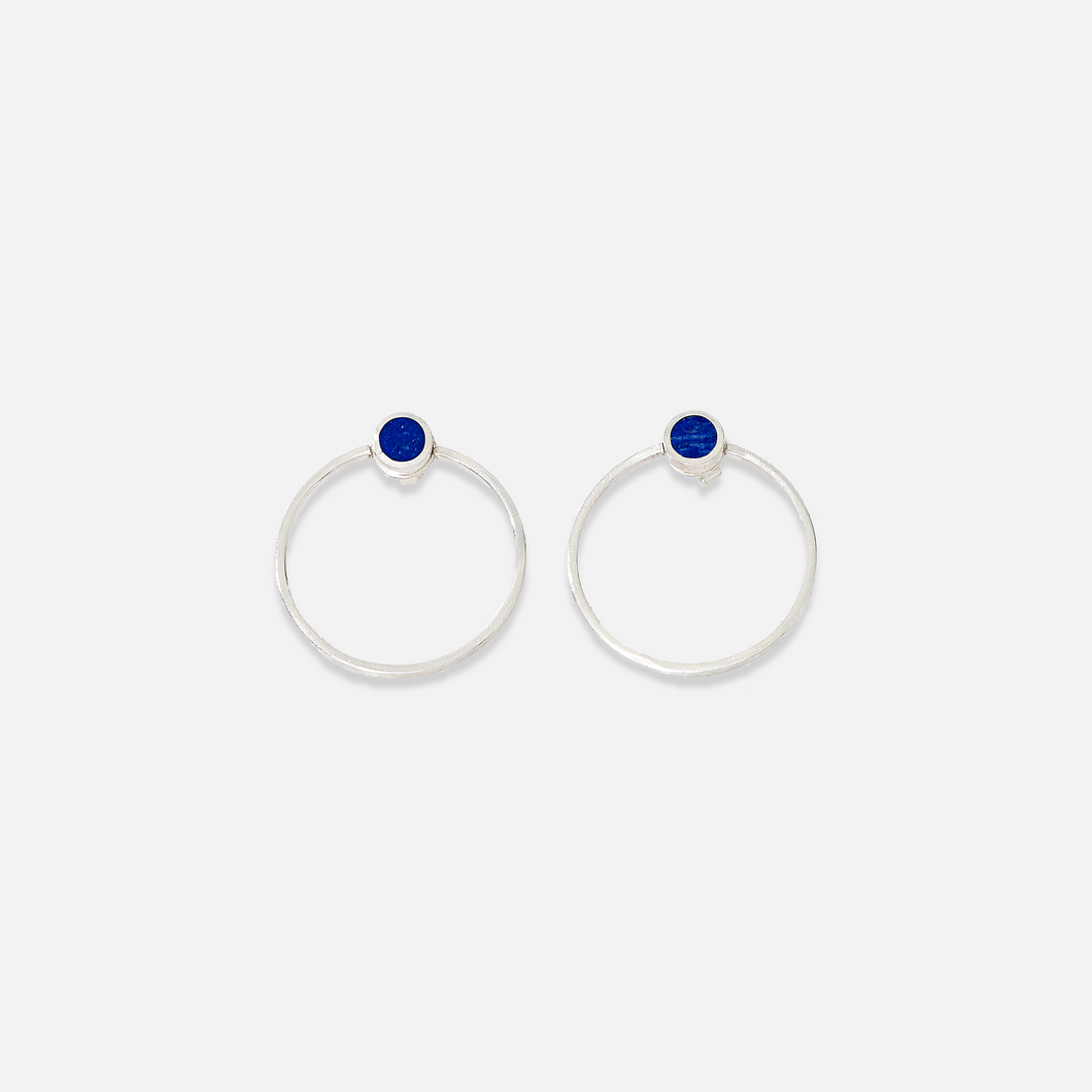 A pair of sterling silver stud earrings with blue lapis lazuli details in the centre.