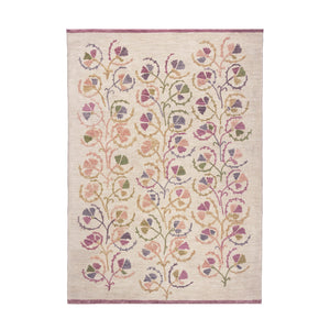 A hand-knotted area rug with a botanical pattern featuring various shades of beige, pink, brown, and green