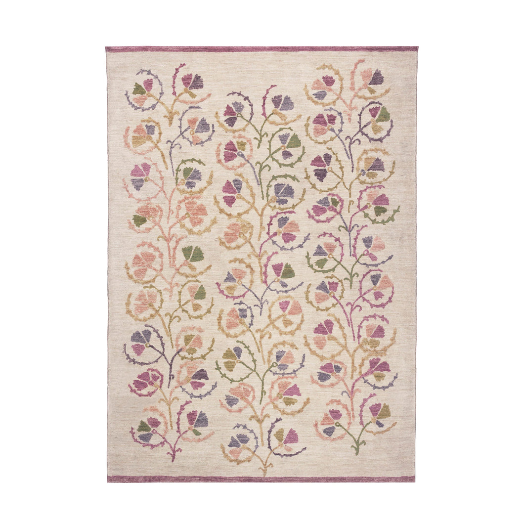 A hand-knotted area rug with a botanical pattern featuring various shades of beige, pink, brown, and green