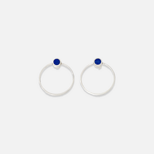 A pair of sterling silver stud earrings with blue lapis lazuli details in the centre.