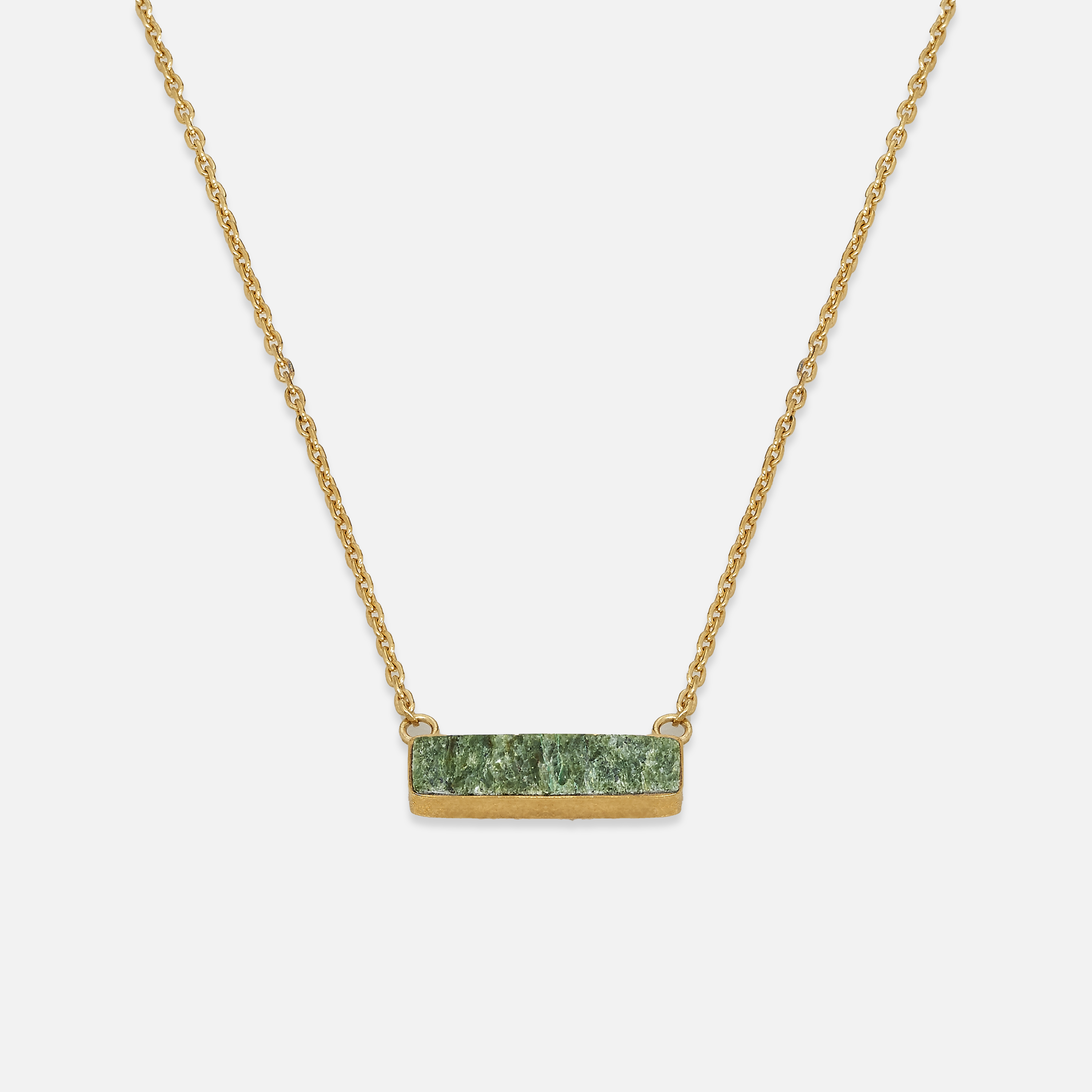 A necklace with a sterling silver chain and a hewn turquoise pendant.