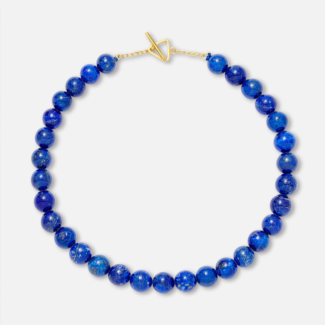 A lapis lazuli bead necklace with a gold clasp, displayed against a white background.