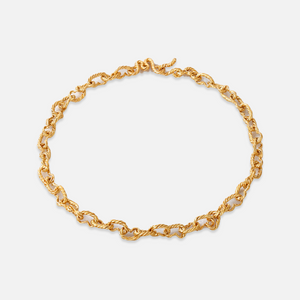 A gold-plated sterling silver choker necklace with a hammered finish and a unique 'M' clasp.