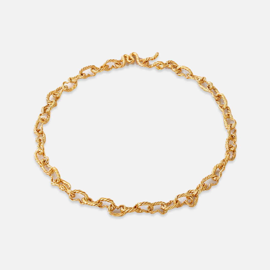 A gold-plated sterling silver choker necklace with a hammered finish and a unique 'M' clasp.