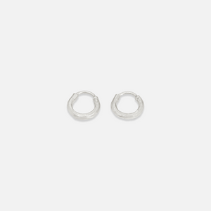 A pair of small gold-colored hoop earrings on a white background