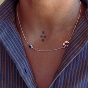 Sterling silver necklace with lapis lazuli and red agate worn by a person in a striped shirt.