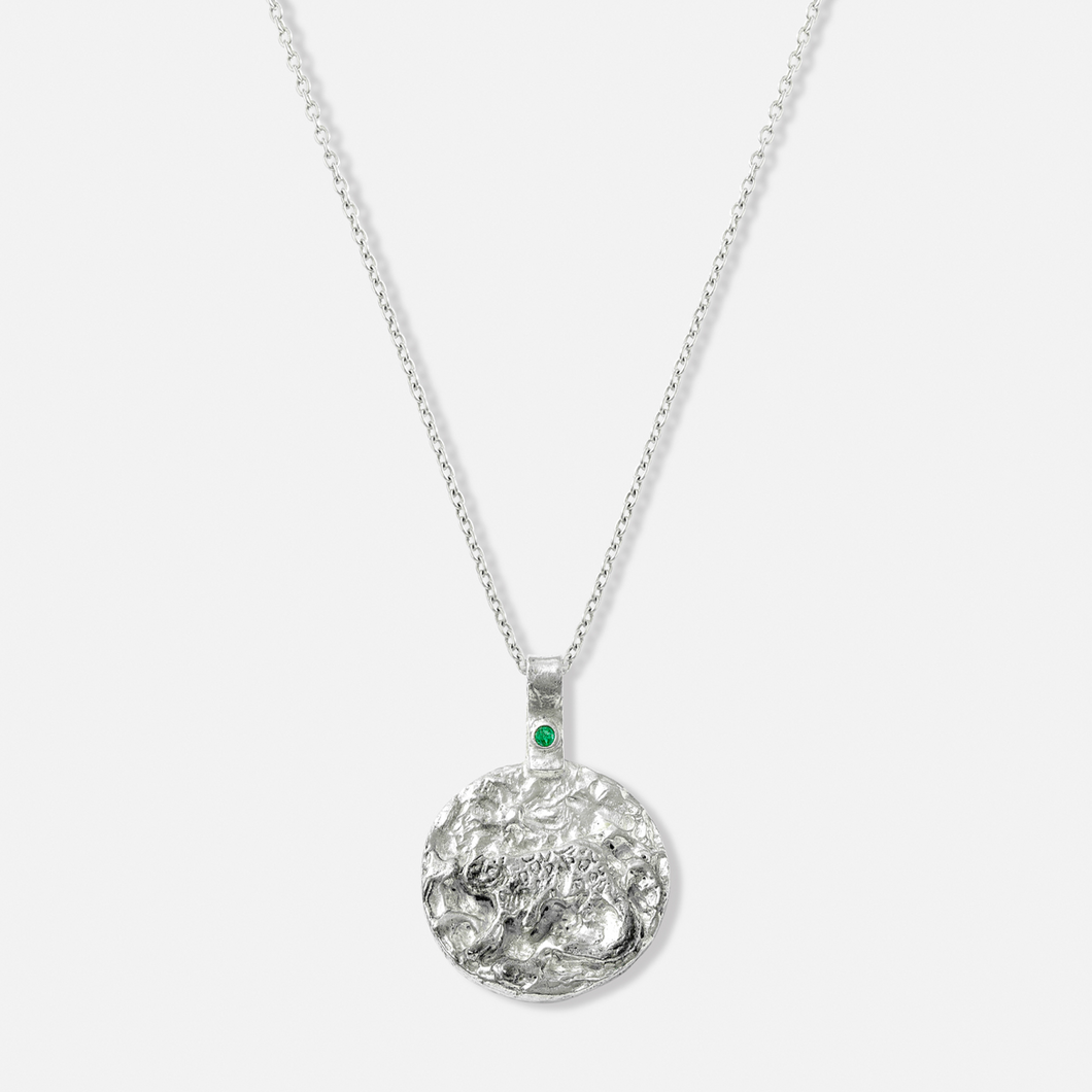 ISHKAR silver necklace featuring a reversible pendant with the snow leopard design on one side.