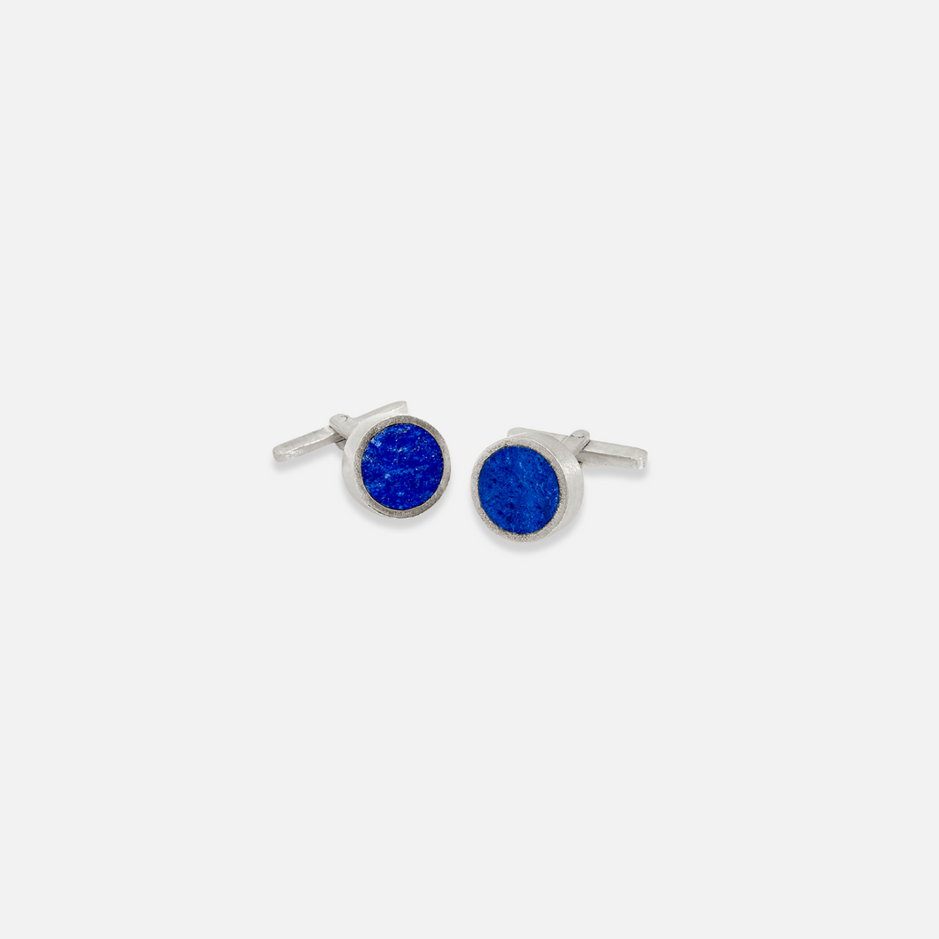 A pair of polished lapis singles cufflinks set against a white background.
