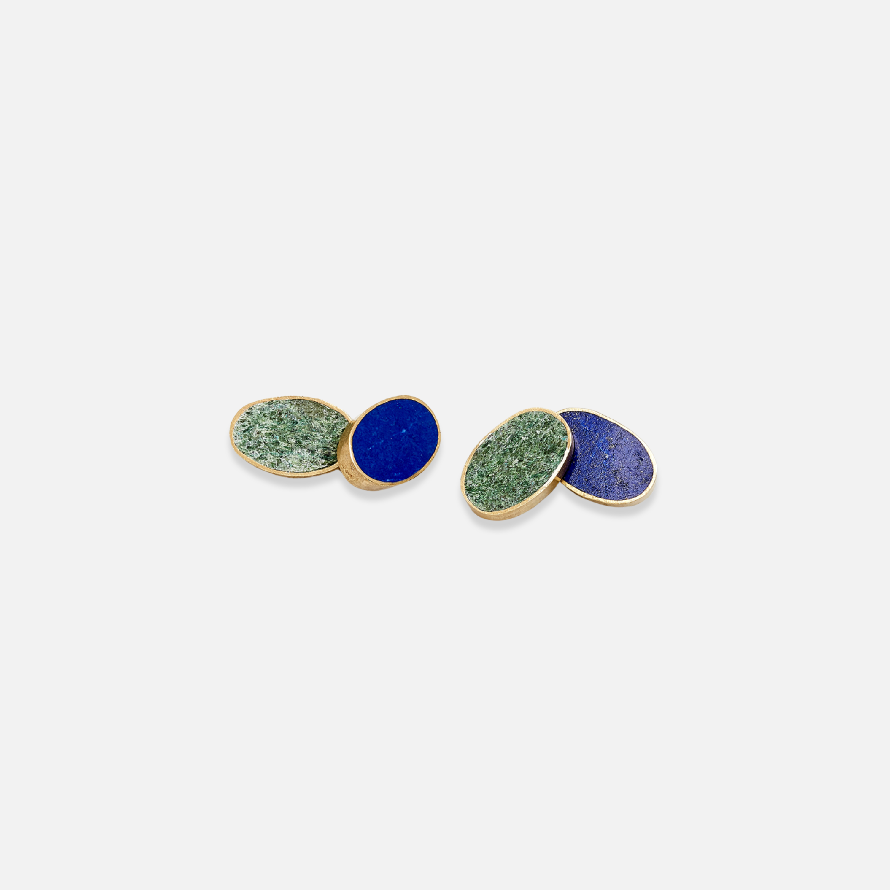 A pair of cufflinks with one half featuring a blue stone inlaid in silver and the other half featuring a green stone inlaid in silver, set against a white background.