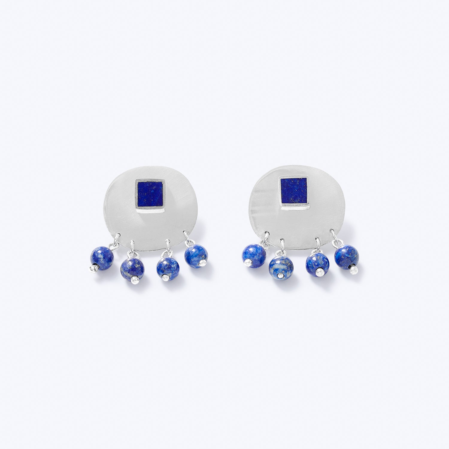 A pair of sterling silver earrings with blue lapis lazuli, featuring a square stud with a detachable back and dangling round beads.