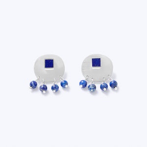 A pair of sterling silver earrings with blue lapis lazuli, featuring a square stud with a detachable back and dangling round beads.