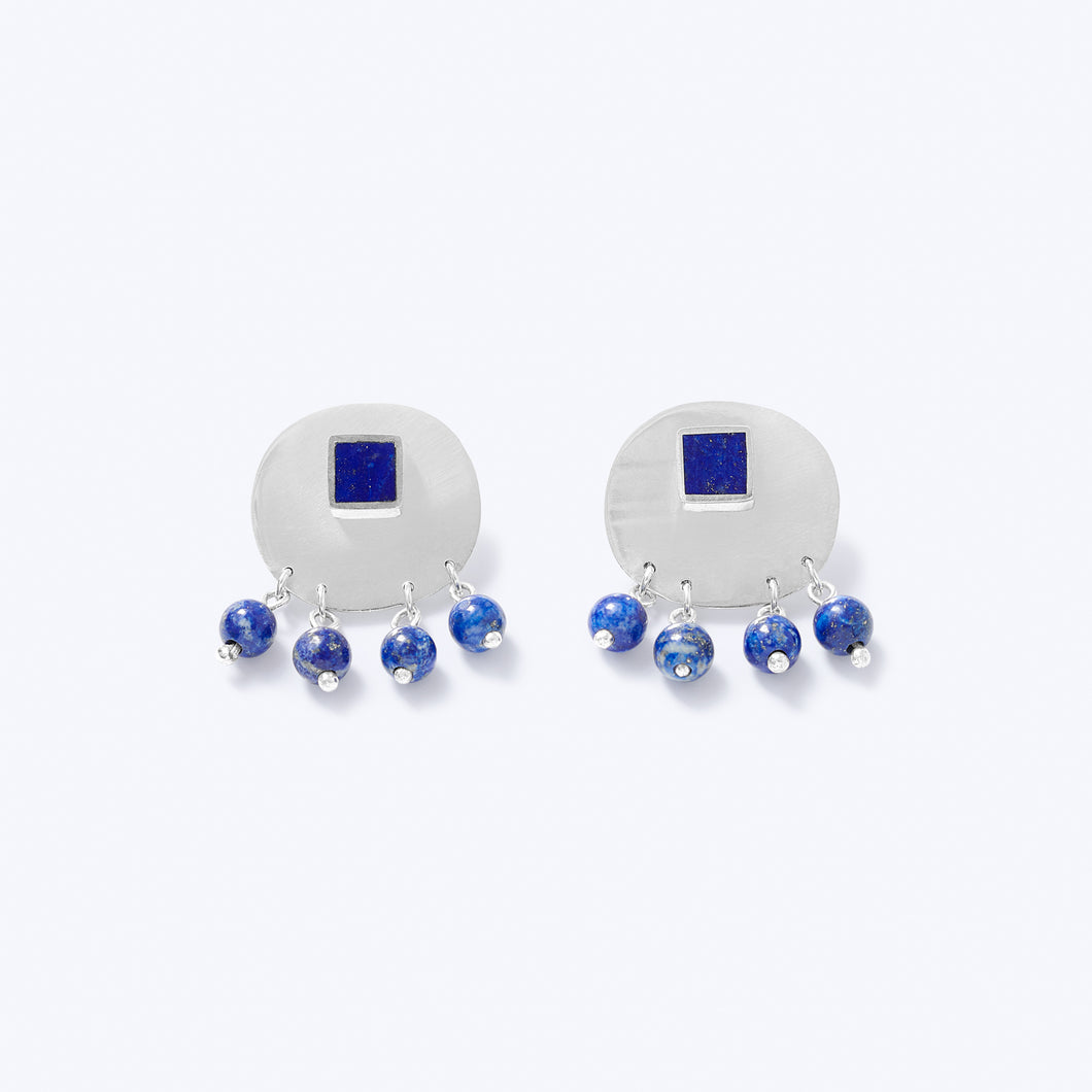 A pair of sterling silver earrings with blue lapis lazuli, featuring a square stud with a detachable back and dangling round beads.