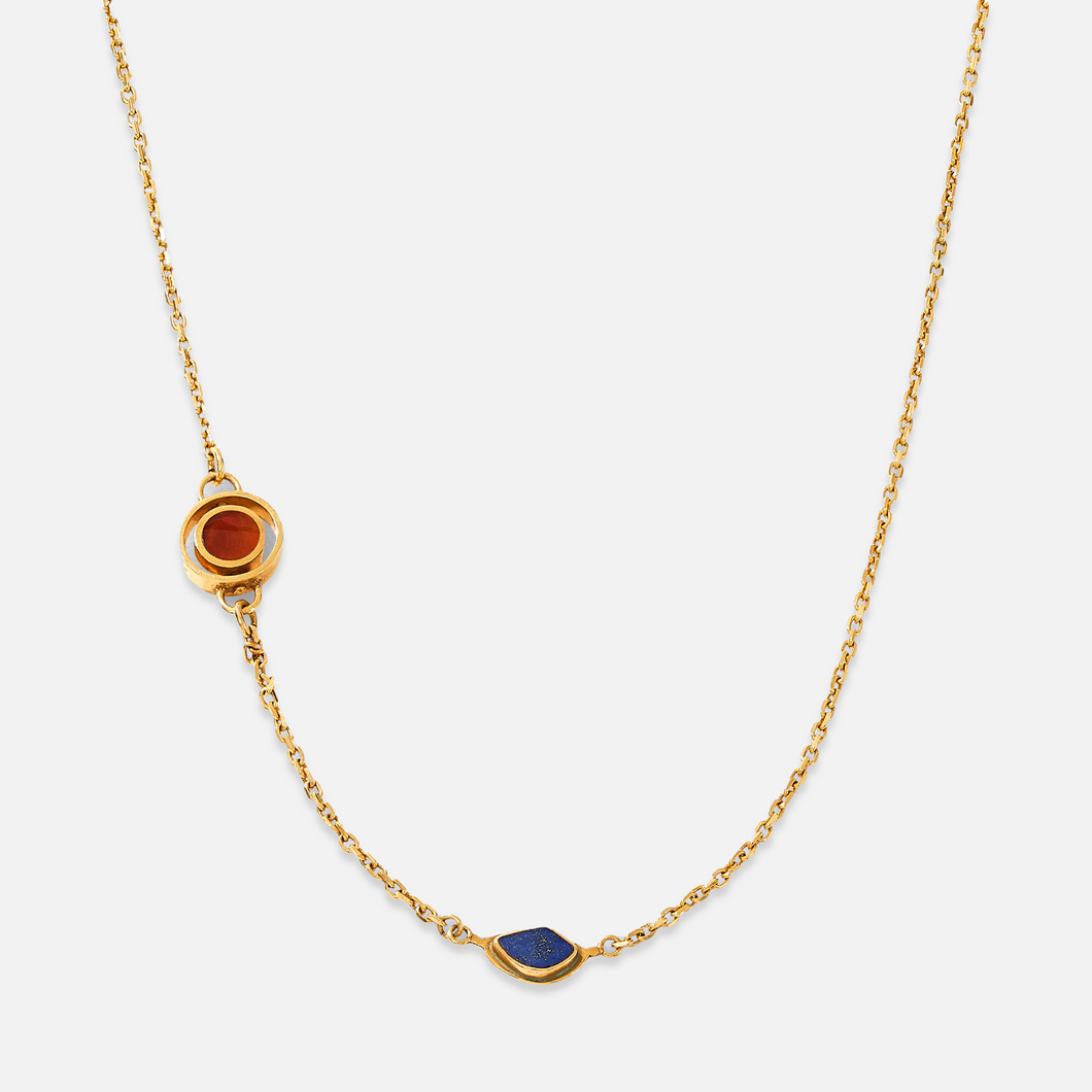 A gold-plated sterling silver necklace with asymmetrical double charms, featuring Lapis and red Agate stones, displayed against a white background.